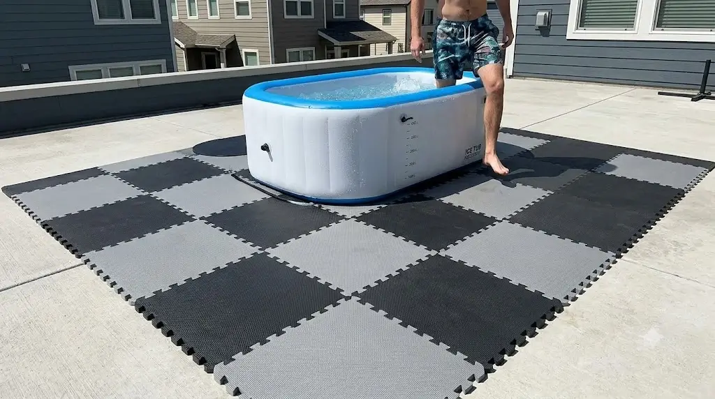 High-density interlocking EVA foam tiles placed beneath an inflatable cold plunge on outdoor concrete